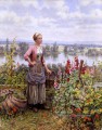Maria sur la terrasse avec une liasse de pelouse Daniel Ridgway Knight Flowers